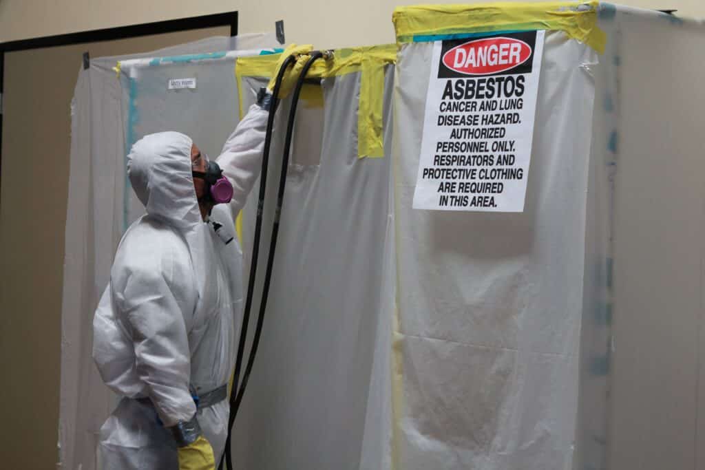 Asbestos Containment with Hazmat Suit Worker