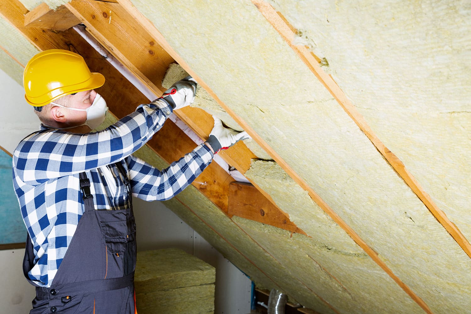 Man removing roof insulation layer