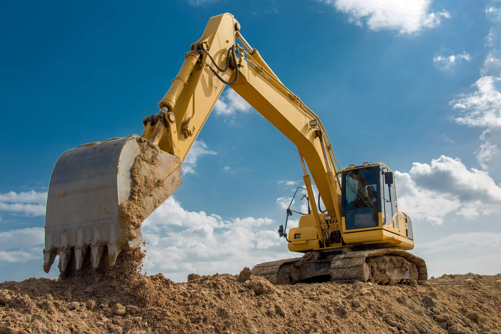 Excavator moving dirt.