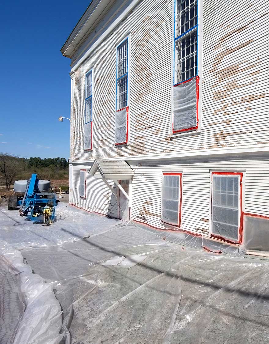 lead_abatement_3 Historic building with windows sealed in plastic sheeting and protective ground covering during professional lead paint abatement.